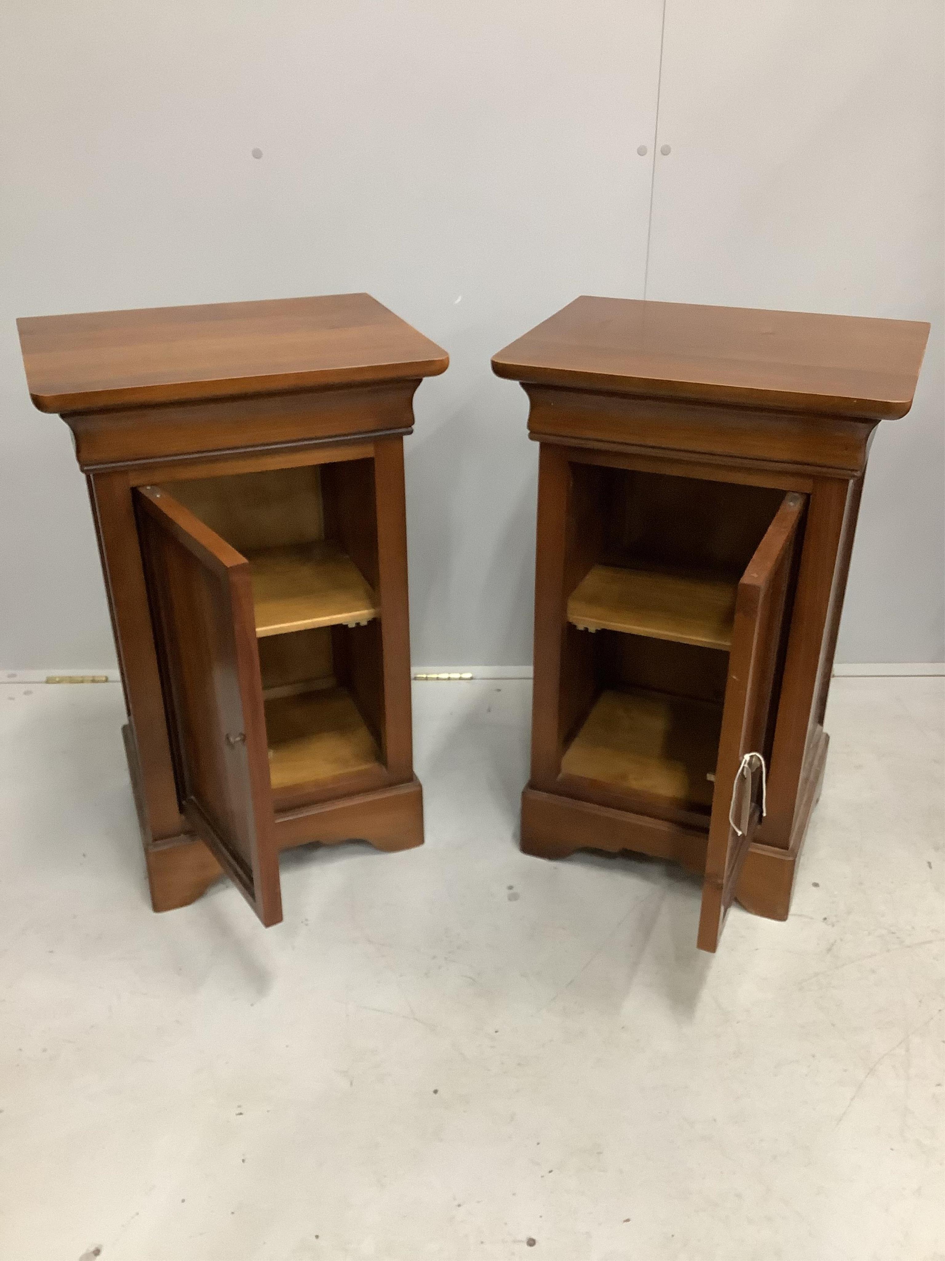 A pair of modern Continental cherry wood bedside cupboards, width 47cm, height 75cm. Condition - fair to good